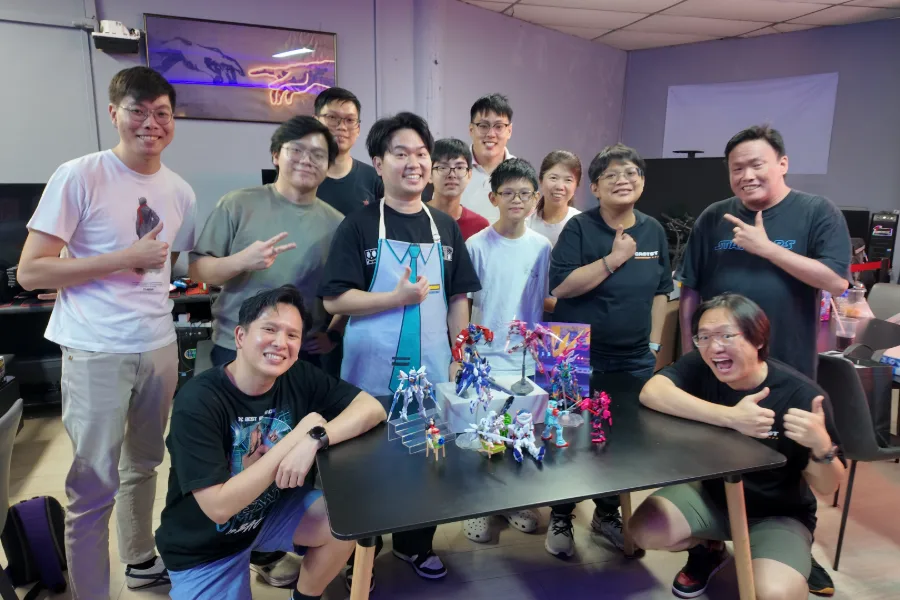 Builders posing with their finished model kits at Good Speed Game Cafe